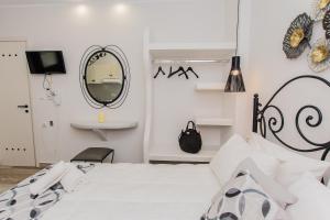 A bed or beds in a room at Naxos Enjoy Apartments