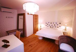 a bedroom with a white bed with stars on it at Boutique Hotel Placa in Krk