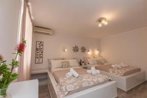 A bed or beds in a room at Naxos Enjoy Apartments