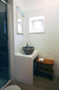a bathroom with a stone sink and a window at Boutique Hotel Placa in Krk +28 photos