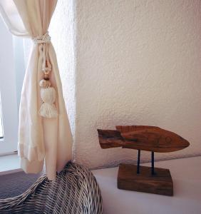 a wooden boat on a table next to a curtain at Boutique Hotel Placa in Krk