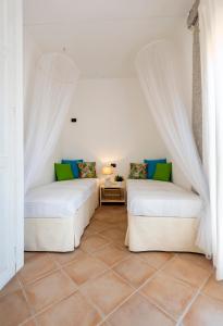 En eller flere senge i et værelse på Villa Ginepro