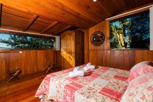 a bedroom with two rabbits laying on a bed at Sunset Strip Eco Apartments in Florianópolis