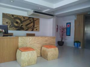 a lobby with two stools in front of a counter at Nantra Hua Hin in Hua Hin