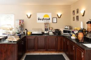 a kitchen with wooden cabinets and a counter top at Days Inn by Wyndham Fairmont in Fairmont