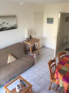 a living room with a couch and a table at Voltaire in La Turballe