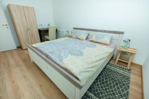 a bedroom with a large bed with a wooden floor at APARTMENT ZYNGA - STUD FARM in Šentvid pri Stični