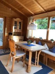 a dining room with a wooden table and chairs at Zirbelhütte in Hohentauern