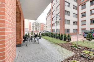 a patio with chairs and a table in a building at Fancy Apartments Old Town in Gdańsk