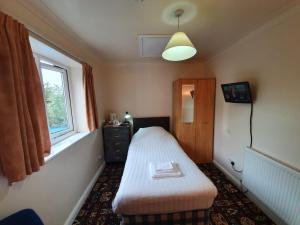 Кровать или кровати в номере The Handforth Lodge