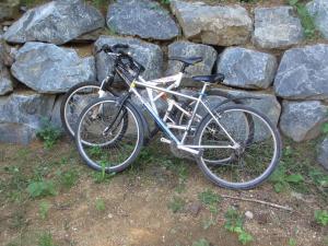 a bike parked next to a stone wall at Foudres du Chêne du Py in Villié-Morgon