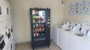 a soda vending machine in a store with drinks at InTown Suites Extended Stay Select New Orleans LA - Harvey in Harvey