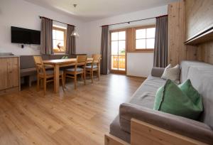a living room with a couch and a table at Klampfererhof in Saalfelden am Steinernen Meer