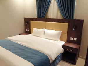 a bedroom with a large bed with white sheets and pillows at همم للوحدات السكنية - الحمدانية Al Hamdaniya in Jeddah