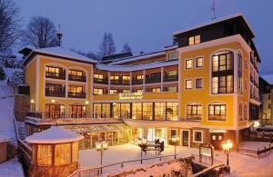 a large yellow building with a lot of windows at Hotel Saalbacher Hof in Saalbach-Hinterglemm