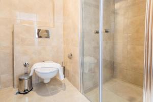 a bathroom with a toilet and a shower at Medimar Hotel in Kaş