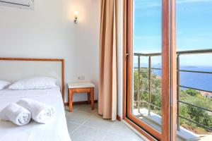 a bedroom with a bed and a view of the ocean at Medimar Hotel in Kaş