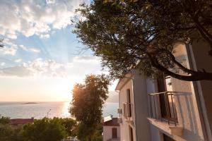 a view of the ocean from a building with a tree at Medimar Hotel in Kaş