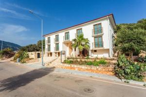 a white building on the side of a street at Medimar Hotel in Kaş