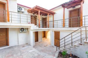 a house with a staircase and a balcony at Medimar Hotel in Kaş
