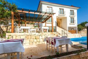 a group of tables and chairs in front of a house at Medimar Hotel in Kaş