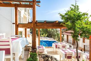 a restaurant with a table and chairs on a patio at Medimar Hotel in Kaş