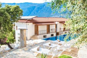 a villa with a view of the mountains at Medimar Hotel in Kaş