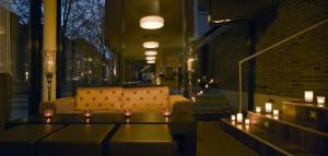 a living room with a couch and candles on a table at Boutiquehotel am Stadtgarten in Freiburg im Breisgau