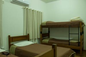 a room with two bunk beds and a window at Pousada Da Campanha in Bagé