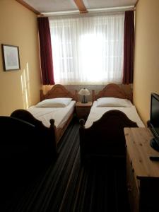 En eller flere senger på et rom på Hotel Alte Rathausschänke