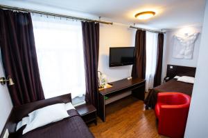 a hotel room with two beds and a window at Primo Hotel in Rīga
