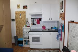 a small kitchen with white cabinets and a stove at A.R.Inter.3 in Brescia
