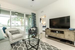 a living room with a flat screen tv and a couch at GreenLinks Golf View Villa Mustang at Lely Resort in Naples