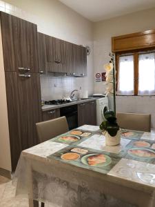 a kitchen with a table with a table cloth on it at Tortora House in Scafati