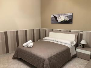 a bedroom with a bed and a painting on the wall at Tortora House in Scafati