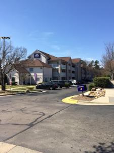 a building with a sign in front of a street at InTown Suites Extended Stay Raleigh NC- Capital Blvd in Raleigh