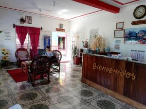 a woman sitting in a chair at a barber shop at Hotel La Union in Flores
