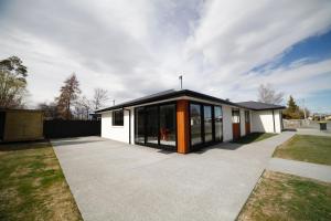 a house with a lot of windows and a driveway at Mackenzie Magic in Twizel