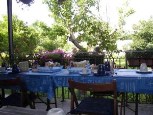 a table with blue table cloths on top of it at Villa Nike B&B in San Foca