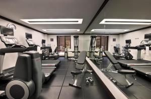 a gym with treadmills and elliptical machines at The Pearl Hotel in New York +37 photos