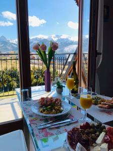 a table with plates of food and glasses of orange juice at Apartament Kasprowy in Kościelisko