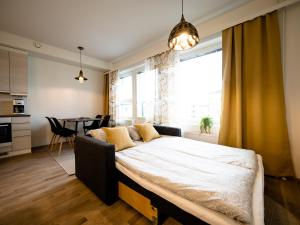 a bedroom with a large bed in front of a window at First Aparthotel Comet in Rovaniemi