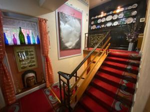 a staircase leading to a bar with a red carpet at Kylemore Pass Hotel in Letterfrack