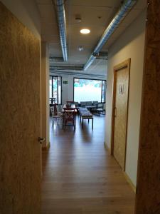 an empty hallway with a table and chairs in a room at Albergue Nacama Hostel Pontevedra EXCLUSIVO PEREGRINOS PILGRIMS in Pontevedra