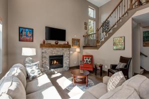 a living room with a couch and a fireplace at Benjamin Place at Jordanelle in Kamas