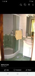 a bathroom with a shower and a tub and a sink at Motel Plavi in Mračaj