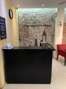 a black counter in a room with a brick wall at Hotel Posada San Juan in Veracruz +26 photos