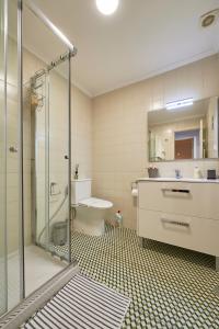 a bathroom with a shower and a sink and a toilet at Aesthetic Riverview Apartment in Historical Lisbon in Lisbon