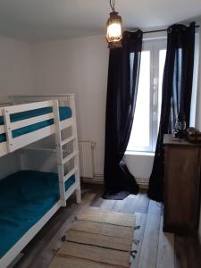 a bedroom with a bunk bed and a window at Repaire des Corsaires Normands in Le Tréport