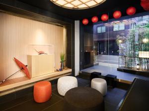 a room with chairs and a red umbrella on a wall at MIMARU Tokyo Nihombashi Suitengumae in Tokyo